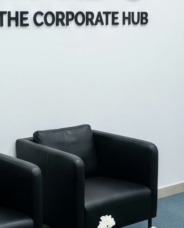 The armchairs beside the Corporate Hub signage