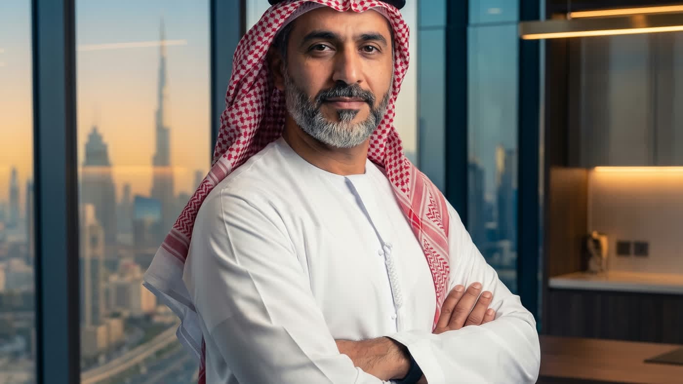 A business owner in an office overlooking the Dubai skyline